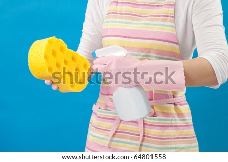 Woman spraying cleaning sponge