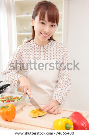 Asian beautiful woman w is being prepared for cooking in the kitchen.