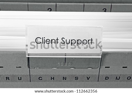 grey hanging file folder labeled with Client Support