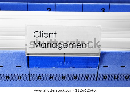 blue hanging file folder labeled with Client Management