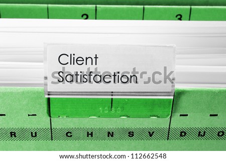 green hanging file folder labeled with Client Satisfaction