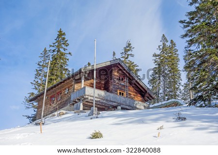 Mountain cabin in winter landscape