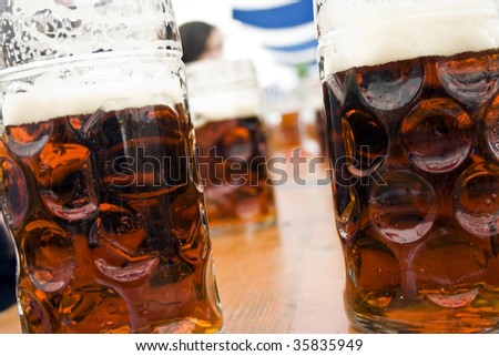 mugs of dark strong beer on bavarian beer festival