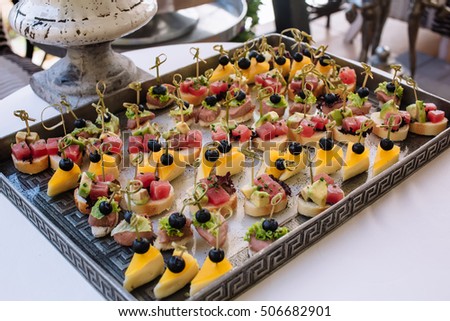 Different light snack.on tray on wedding party