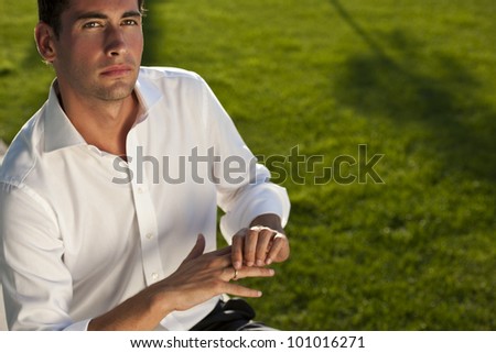 Pensive young man touching his wedding ring, maybe not sure of his choice