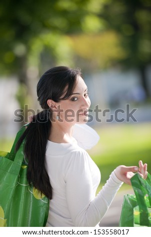 Beautiful young woman with reusable bags