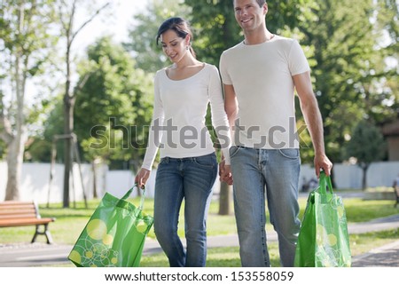 Young couple with reusable bags