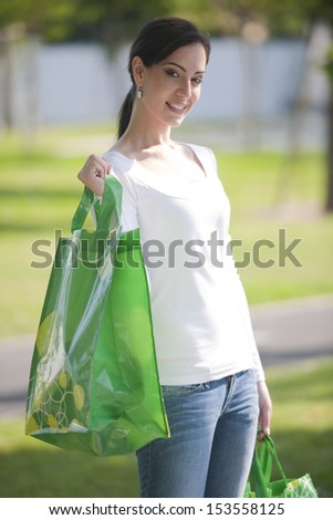 Beautiful young woman with reusable bags