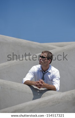 Businessman on a stairs, looking sideways