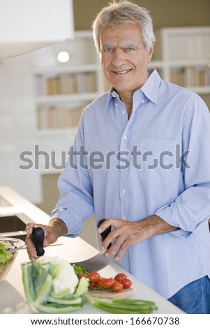 Happy senior man cooking healthy food