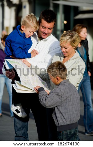 Family looking at map in town