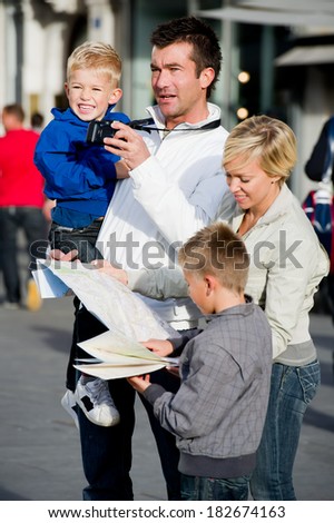 Family looking at map in town