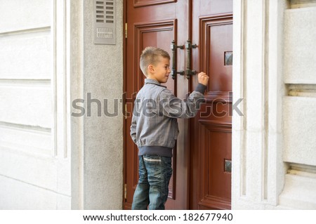 Little boy knocking the door