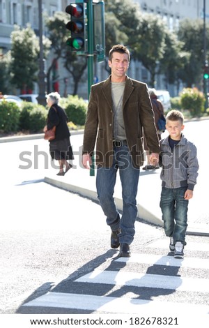 Father and son crossing the cross walk