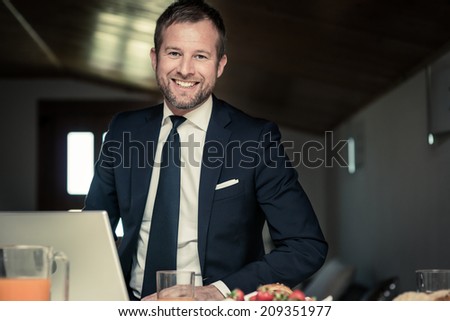 Happy businessman working at home