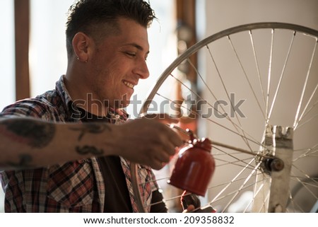 Young man working in a biking repair shop