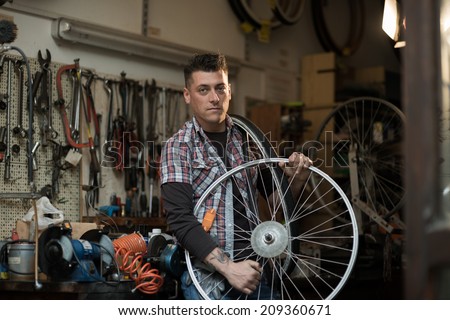 Young man working in a biking repair shop