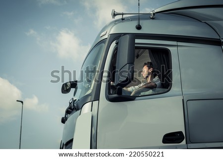 Portrait of a truck driver sitting in cab