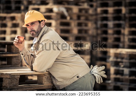 Warehouse worker having a break with coffee
