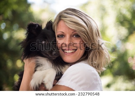 Portrait of a woman with her cute dog at the park