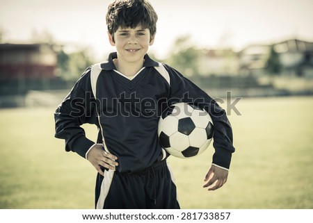 8 years old girl holding soccer ball