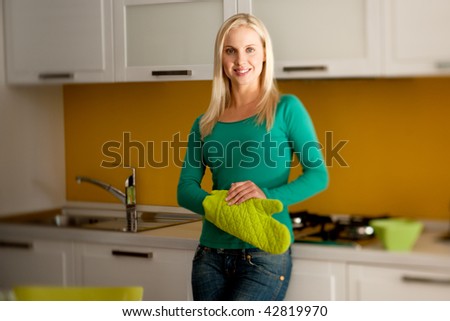 Young woman wearing oven glove