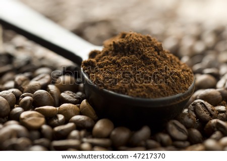 Coffee beans and ground with spoon