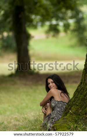 Pure, natural, beautiful young woman in nature, sitting under a tree. Taken in Lipica, Slovenia. Concept: teenagers and nature