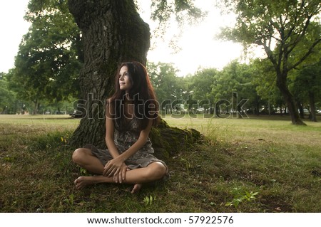 Pure, natural, beautiful young woman in nature, sitting under a tree. Taken in Lipica, Slovenia. Concept: teenagers and nature