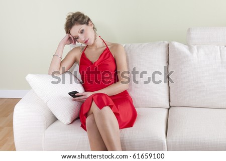 Disappointed woman waiting a call; she is ready to go out
