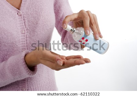stock photo Woman squirts a squirt of antibacterial liquid soap into her stock photo Woman squirts a squirt of antibacterial liquid soap into her