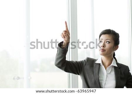 Chinese Businesswoman Pointing at Copy-space