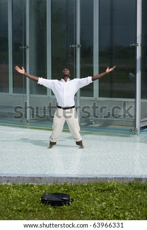 Businessman in the pool outside his office;  he could be excited because he has just resigned