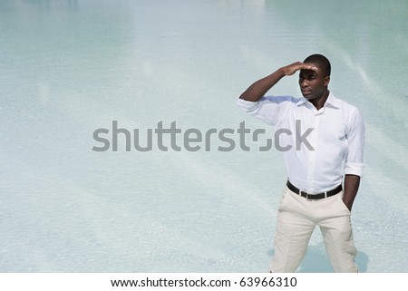 Businessman looking into in the future, water in the background, lots of copy-space