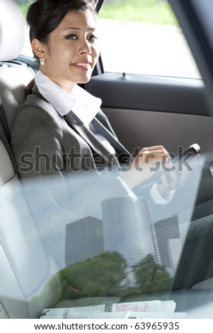 Young chinese business woman inside a car