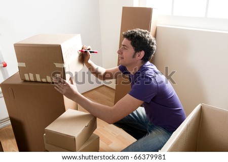 Young man packing boxes