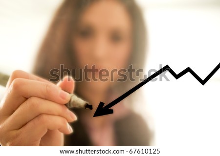 Businesswoman drawing a decreasing graph, focus on the graph
