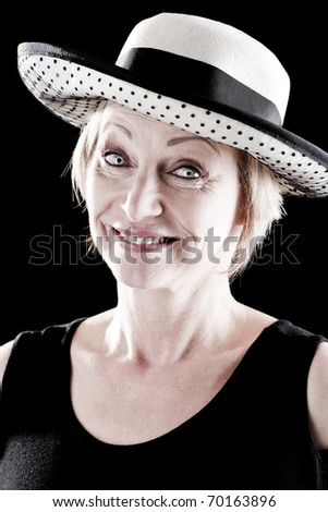Woman with hat performing on stage, black background