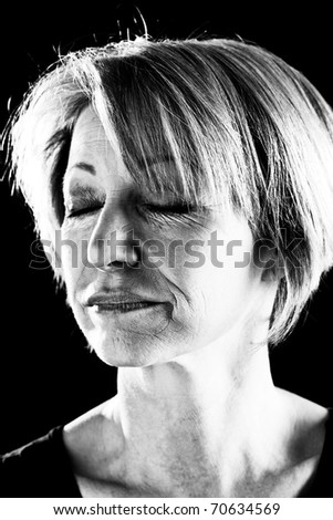 Close-up of a beautiful mature woman with eyes closed, portrait/actress on stage-black and  white image
