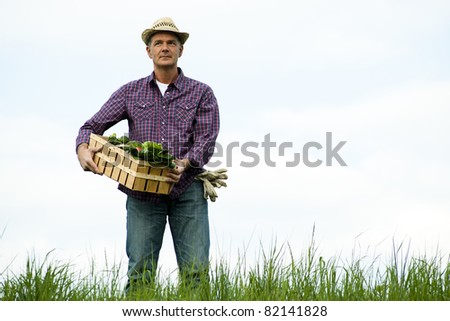 Farmer carrying  a crate of vegetables