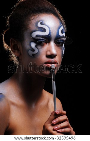 Portrait of mulatto girl with face-art, body-art