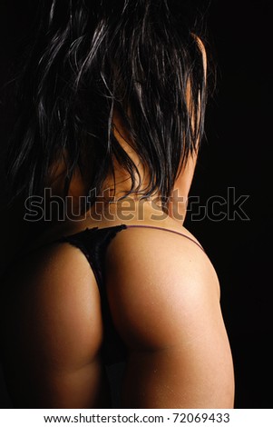 stock photo Beautiful ass of young woman over dark background