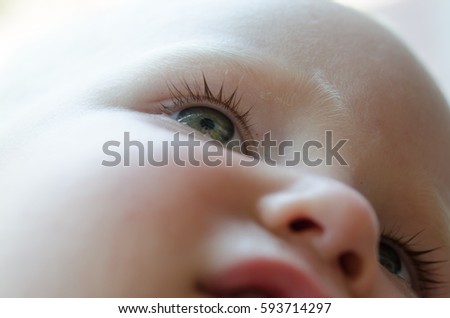 Little baby is crying. Tears in her eyes close-up.