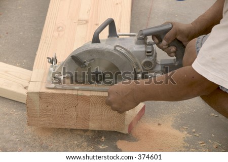 Sawing wood at new house construction.