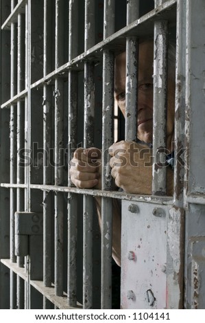 Prisoner in old jail cell.