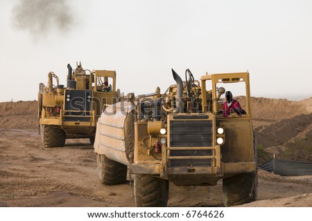 Earthmovers in the desert at new housing and roads projects.