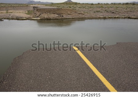 Road washed out by flood in Arizona desert.