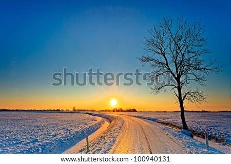 Sunset in a cold white winter landscape