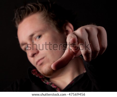 Man pointing his finger at you isolated on black