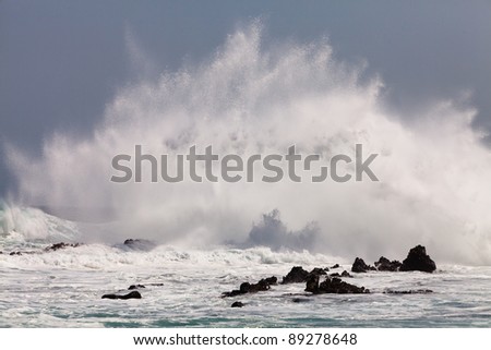 High wave breaking on the rocks of the coastline